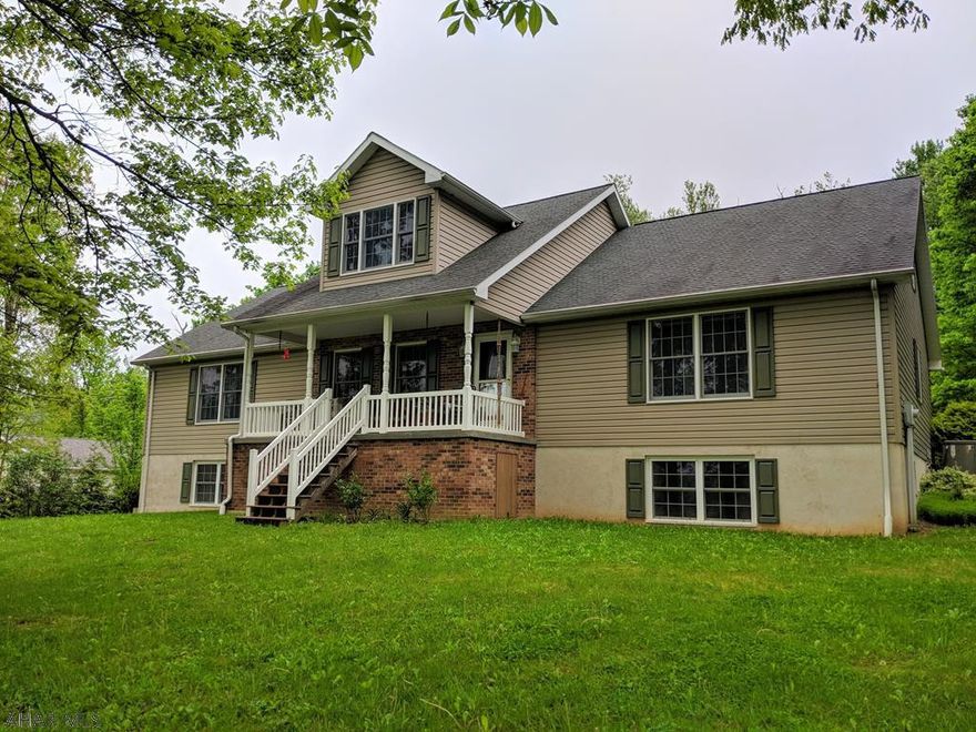 Beautiful country home surrounded by forest and fields.  Sit out on the front porch and take in the scenery. This home has it all! A gorgeous kitchen with quartz counter tops, a double oven, cook top and eat in area. First Floor Laundry. Great room is spectacular with new flooring and vaulted ceilings. First Floor Master with spacious master bath. Second floor features a sewing area and two bonus rooms currently used for storage. Both could easily be finished for bedrooms. One has plumbing ready for a second master suite. Two more bedrooms and a full bath on the main floor. Downstairs has a small apartment with separate entrance featuring a kitchen/living area, bedroom and full bath. There is also a family room, a dog grooming shop and storage. Plus a two car garage and a detached garage!