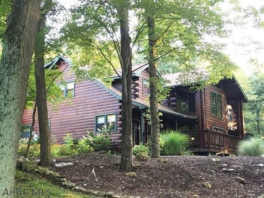 Truly fabulous, one of a kind, custom log home situated on a large 2 acre wooded lot.  Total seclusion, but only minutes to schools.  New carpeting and new updates to kitchen.  Open floor plan. Large rooms.  Central air.   Watch wildlife from the comfort of the great room with two-story windows, or take it outside to the wrap-around deck or screened porch.  You will never want to stop entertaining family and friends in this remarkable home.