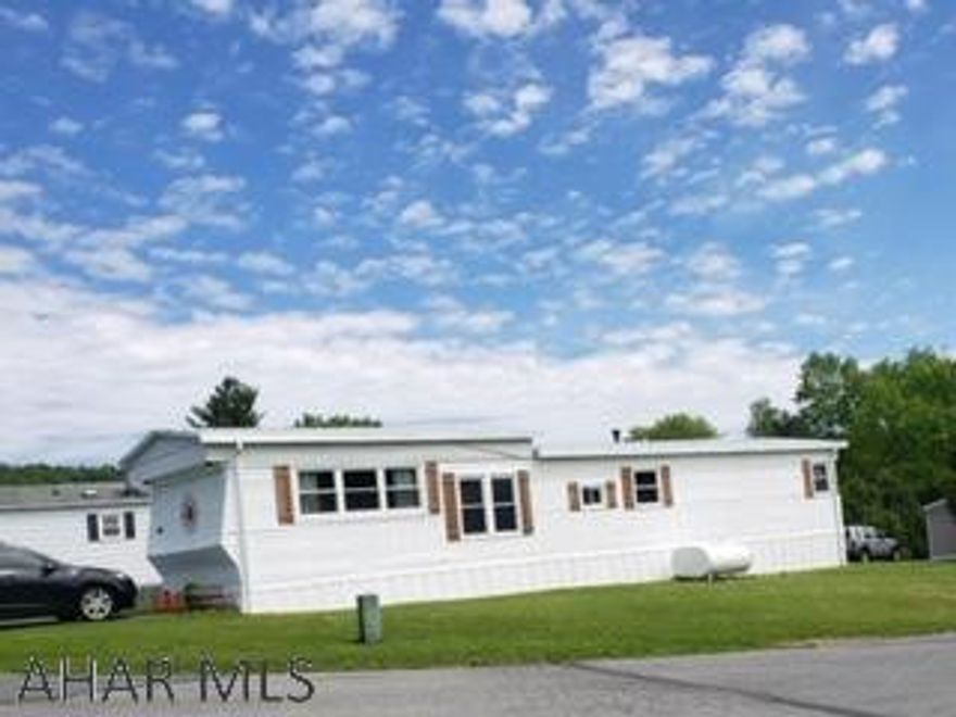 Cute singlewide with laminate flooring on corner lot.  New furnace in Oct 2017.  Stackable washer & dryer included in the updated bathroom.  Buyer must be approved by park.  Lot rent of $389.50 includes water, sewer and trash.