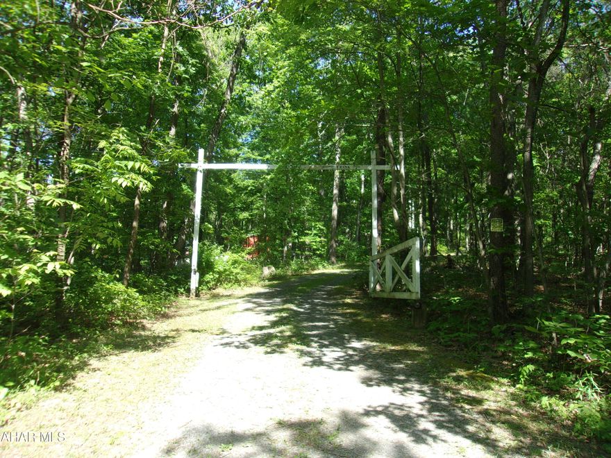 Welcome to Jeremiah Way!  Almost 18 acres of peace and solitude. Oh, you won't be lonely! Follow the old logging road through the woods.
There's lots of wildlife to watch and keep you entertained. Deer, fox, bear, the occasional bobcat, even hummingbirds! 

All the work has been done to get ready to add septic and electric to the ''tiny house''.  This little charmer has just the basics and can be finished to your liking.  Or build your dream house and keep the ''cabin'' as guest quarters.  

Vacation get away, hunting cabin, - maybe a retreat to tuck yourself away and write the  Great American Novel, photograph/sketch native plants and animals, or just ''be still''.

But don't worry.  You are not cut off from civilization.  Where else can you find seclusion, but still have cell service.

Piney Grove Subdivision yearly $100 road maintenance fee.