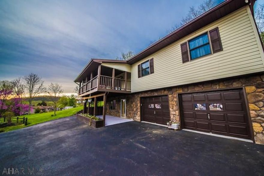 If you are looking for a spacious home with gorgeous views don't miss this Hollidaysburg home. An open floor plan with a kitchen island rolls into a large covered front porch with 180 degree mountain view. If woods are more your scene you can relax in the first floor sun-room to watch the birds or falling rain. This home has three large bedrooms, a walk in closet, and three full baths. The basement has a bar with ample room to entertain. It is adjacent to the popular Rolling Hills Subdivision. There is a detached garage with second floor apartment opportunities.  This property also includes a separate parcel with utilities that can be sold off for a building lot.  The kitchen and bathrooms have brand new flooring.