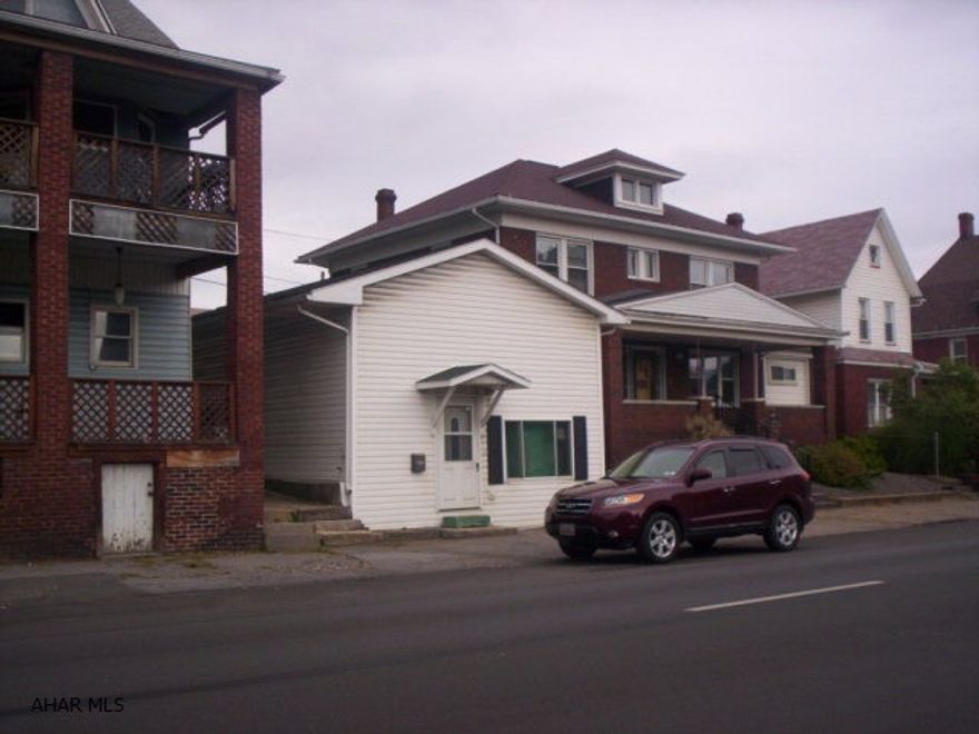 Newer roof, hot water tank and furnace for front building; back building also has newer roof. All items in back storage building will be removed. Table, chair, lawnmower and all other personal items in front building will be removed. Great location for start-up business. Property sold AS-IS, owner will make no changes/repairs etc.Ask Agent for more information on changes and repairs already made by the current owner.