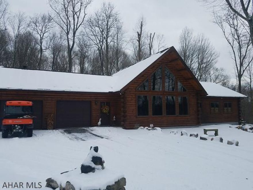 Meticulously maintained log home built in 2002 with 1 owner, on 7.37 acres in Hollidaysburg School district. If you are looking for a move in ready SECLUDED home with STUNNING views you must see this! The home features an open floor plan with a living room, dining room, and kitchen with breakfast bar.  Laundry room can be used as a 3rd bedroom and laundry can be moved to heated garage.  Central Vac throughout the home. Nice sized bedrooms with natural light and views from any place in the home. LARGE bathroom with separate shower stall and large Jacuzzi tub. Unfinished basement can be finished to add additional square footage for entertaining. OVER SIZED 2 car heated garage with a wood burner and half bath. Do not miss this AMAZING home, call listing agent for your tour today! NO DRIVE BY