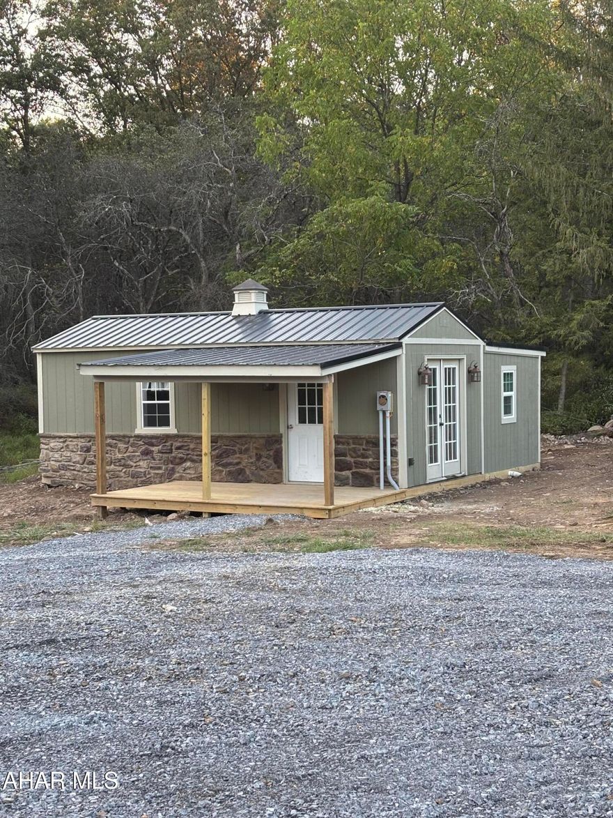 Looking for a low-maintenance getaway? This 300 sq ft tiny home offers everything you need in a compact space—all within minutes of Lake Raystown.

Featuring public water, sewer, and electric, the home includes a full bathroom for convenience. Outside, you'll find room to park your boat or expand on the lot to suit your needs. The property's location provides easy access to State Game Lands for outdoor recreation, and it sits within the Tussey Mountain School District.

Whether you're seeking a cozy retreat, hunting camp, or base for lake adventures, this property is ready to welcome you.