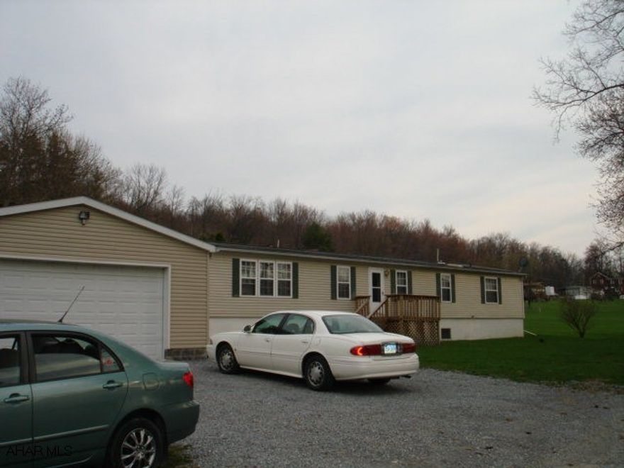 Beautiful three bedroom, two bath double wide on lot 100 x 120. Features family room, master bath with garden tub, fenced yard, full basement, and a large four car garage attached to home with a breezeway. Central Air