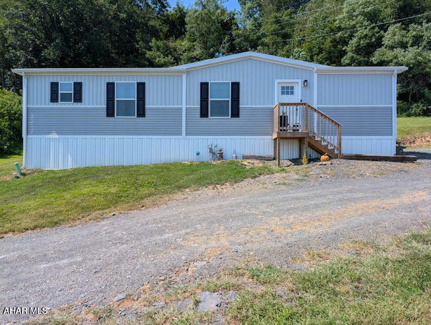 Charming Modern Living Awaits in Osterburg, PA!  Welcome home to this delightful newer double-wide oasis nestled on a sprawling 1.026 acres within the sought-after Chestnut Ridge School District. This stylish residence offers an exceptional blend of modern design and serene country living.

Step inside to discover a bright and airy open floor plan that seamlessly combines comfort and style. The spacious living area is adorned with modern finishes, creating an inviting atmosphere perfect for entertaining or cozy nights in. The chef's kitchen boasts sleek cabinetry, generous counter space, and updated appliances—ideal for hosting gatherings and showing off your culinary skills.  

With three bedrooms, including a relaxing master suite complete with an en-suite bath, you'll have ample space for privacy and relaxation. Each room is designed with natural light in mind, providing cozy spaces to unwind after a long day.

The gorgeous views of Bedford County's country side, provides endless opportunities for recreation and entertainment. Imagine hosting gatherings under the stars or simply enjoying peaceful mornings sipping coffee on your porch as you take in the scenic beauty.  Call today to schedule your private tour.  Your new home awaits.