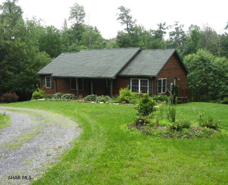 Get away from it all in this cedar sided beauty nestled in the mountains of the quiet Folmont Development.  Year round access, welcoming front porch, landscaping, relaxing deck and fire pit just ready for evening gatherings with friends and family are what you can expect from this home.  The unfinished basement could be turned in to more living, is plumbed for an additional bath and previously had a wood burning stove.  Located just minutes from historic Fort Dewart and Shawnee State Park and Lake.  Ask about the additional adjoining 5.01 acres that can be purchased.  Restrictions apply.