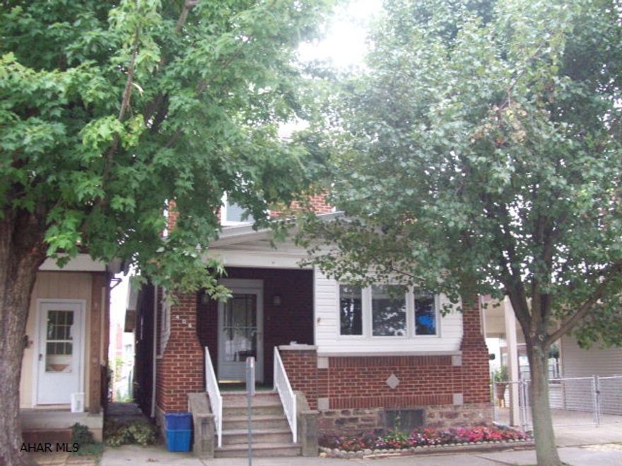 Solid 3BR brick home having hot water heat, natural oak trim, stained glass windows.  Two-car detached garage.