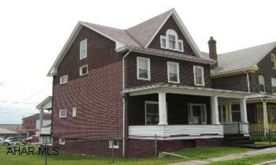 Two story home in need of remodeling.  Large rooms.  Nice entry.  Fenced in double lot.  Attic could be a fourth bedroom.  Loads of potential!