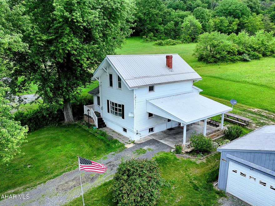 Huge PRICE Reduction ! This house is all about the lovely mountain views! Has a double lot, extra lot has some fruit trees and space for a large lush garden. Home has a small kitchen, dining room, living room , foyer with wood burning stove and half bath which has the laundry area.  All orginal hardwood floors in the living room and dining room. Upstairs there are three bedrooms and a bathroom with a tub. Seller currently heats with the woodstove, but the home also has hot water oil heat.  Outside nice size detached garage and separate shed. Public Water and Sewer. Just mnutes form I-99 for an easy commute. Call to take a look.