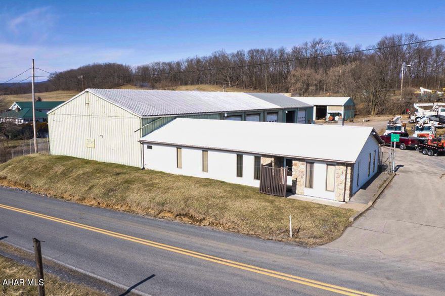 This is a great opportunity for anyone looking to own a commercial garage with office space in Hollidaysburg. With the large lot size and multiple buildings included, there are indeed many possibilities for how the property could be used.

The buildings are situated on almost 4.5 acres and include an office which is about 2,471 sqft, a 5 bay garage that is approx 7,600 sqft, and a separate storage garage that is 1,920 sqft.

Some potential uses for a property like this could include:

Vehicle repair and maintenance: With a 5 bay garage included, this property could be a great location for a business focused on vehicle repair and maintenance. The office space could be used for administrative tasks and client meetings.

Equipment storage and rental: Alternatively, the garage and storage garage could be used for storing large equipment like construction machinery or agricultural vehicles, and the office space could be used for managing a rental business.

Warehousing and distribution: The large lot size and multiple buildings make this property well-suited for warehousing and distribution operations. The garage bays and storage garage could be used for storage, and the office space could be used for managing inventory and coordinating shipping and receiving.

Of course, these are just a few examples of how the property could be used. Ultimately, the best use for the property will depend on the needs and goals of the buyer!

Plot image shows approx property lines and is for reference only.