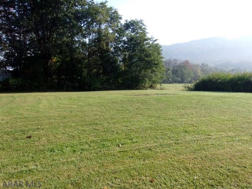 Nice, relatively flat lot.  Could be used to build or place a mobile or modular home.  Water is available approximately 60' from lot and sewer is available approximately 25' - can be ran to lot at buyers expense plus tap fees.   Estimated taxes for 2017 are $86.60;  however, this is only an estimate by the county and may change.