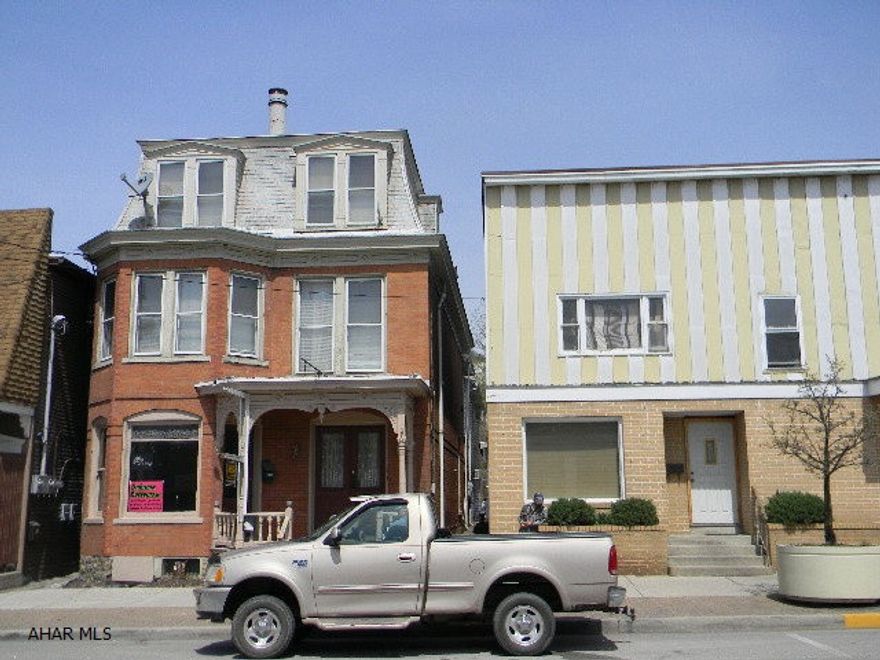 Nice quality investment property! Main Street location w/excellent visibility & exposure. two 1st level retail spaces, three apartments, & basement w/potential for another apartment. Very well built w/oak floors & trim, oak pocket doors, oak entry staircase & brick walls. Current owner has completed many updates. Street to alley lot w/ off street parking.