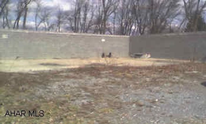 3 SIDED BLOCK BUILDING ON CEMENT SLAB, COULD BE FINISHED FOR GARAGE OR STORAGE, ETC.