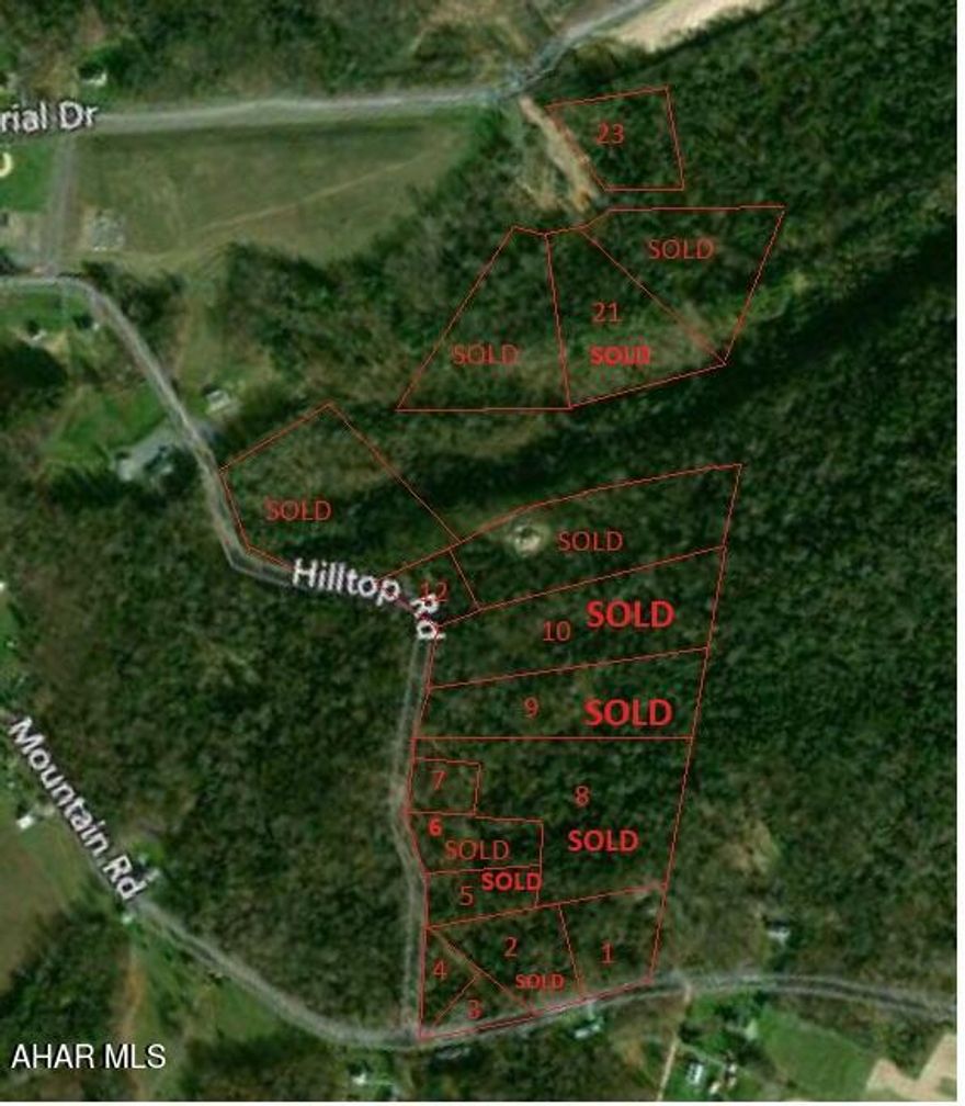 Must see Wooded slight slope to level building lot bordering Mountain Road. Sewer lateral to lot line.  Electric along Mountain Road.  Buyer to drill well. (City water line is a distance away but there is a possibility to extend it to lot at buyer's expense.) Buyer to assume all costs/fees associated with extension/connection to any utility, storm water management and obtaining of necessary permits.
One of the owners is related to a real estate agent(s).  Taxes to be assessed at time of sale.