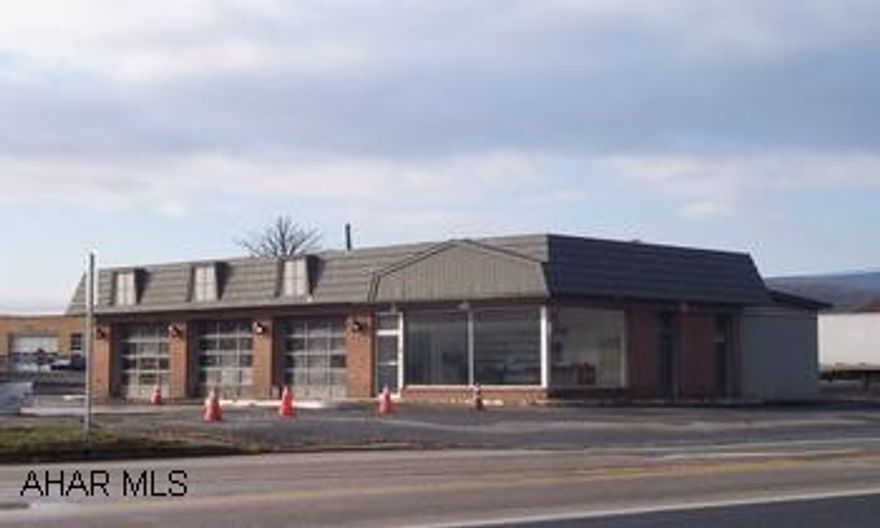 brick one story with 3 garage bays Was a gas station, tanks have been removed, can be converted to  many possibilities, retail, pizza shop, sandwich shop, convenience store etc.