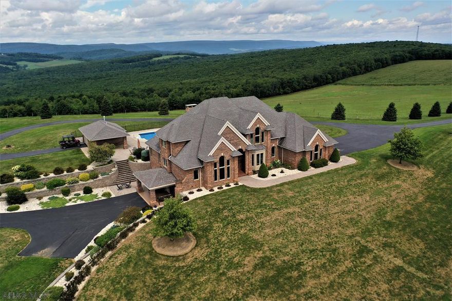 Absolutely stunning property resting on 225 acres & offering some 40-mile views of the countryside! Excellent quality w/ no expense spared in this build. All brick exterior construction, 2-story foyer w/ custom curbed oak staircase; 3-coat plaster ceilings & walls with skip trial finishing; Brazilian cherry, marble & granite floors; & geothermal heating & cooling (zoned). Solid panel wood doors; over sized thermo pane windows; & all custom built wood trim for windows & doors. Large brick entry pillars w/ security gates & bronze eagles leading up the 1/2 mile paved driveway; deco house pillars capped w/ granite slabs; 20'x40' in-ground/heated pool; brick pool house; paver patios & walks. Easy access to Pittsburgh, Somerset & major roads. Tour at:  https://www.youtube.com/watch?v=KBoF60oHArI