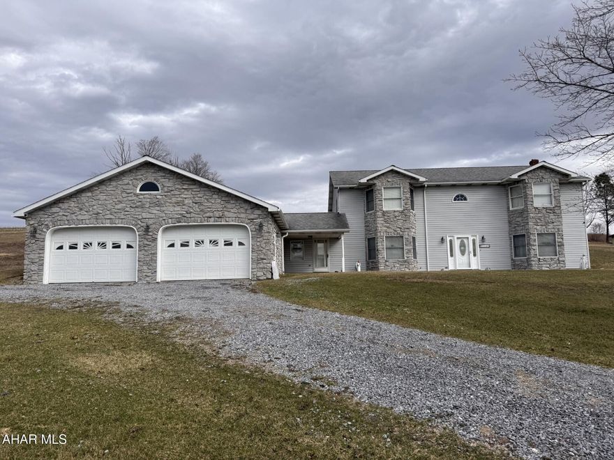 Vinyl & stone raised ranch home on 1.7 acres.  3 BR's & 2 baths on main level.  Finished lower level for additional living quarters.  32' x 40' attached garage & 40' x 60' detached garage that could store a motor home, backhoe, and many other toys or a great workshop.  Possibilities are endless.   A must see!