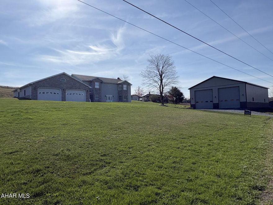 Vinyl & stone raised ranch home on 1.7 acres.  3 BR's & 2 baths on main level.  Finished lower level for additional living quarters.  32' x 40' attached garage & 40' x 60' detached garage that could store a motor home, backhoe, and many other toys or a great workshop.  Possibilities are endless.   A must see!