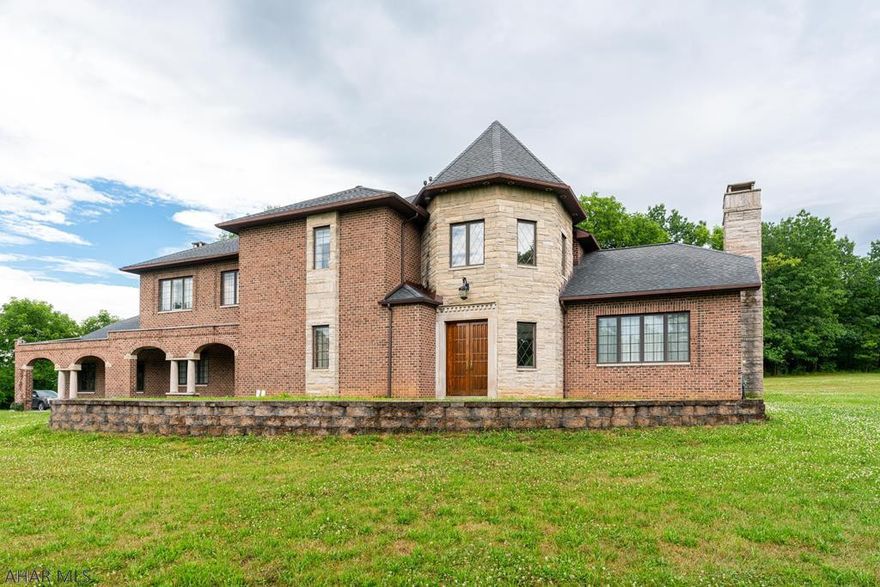 Brick and stone, 6000 sq foot,  2 story home in a private Frankstown Township location...but only minutes to everything.  2 story foyer with marble floors, leads to a spacious living room, dining room and bar.  The first level also consists of a large Family Room with cozy fireplace, eat-in kitchen, (appliances stay), laundry, study and half bath.  Upstairs does not disappoint with amply sized rooms, an owners' suite, dressing area and tiled bath and loft.  Still need more space??  The lower level is finished, complete with a bath and storage. Zoned heat, views and situated on 8 acres...more acreage is available.  This home was custom designed and built...a true treasure.