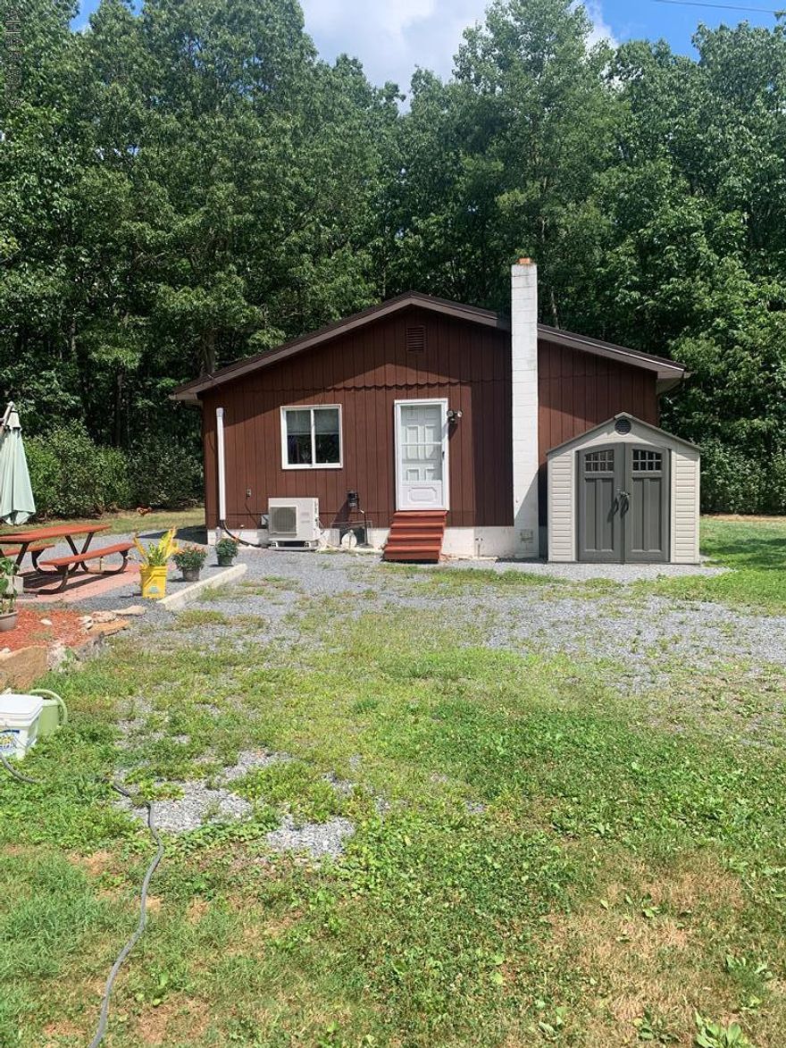 3 Bedroom Home with 4 vehicle metal garage - 30'x40'.  2 heat pumps and pellet stove in home.  Large eat-in kitchen.  2 peach trees, 4 apple, black walnut, wild cherry.