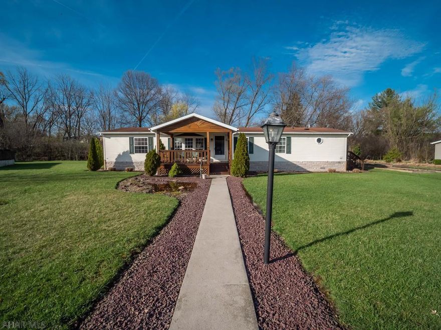 Very large Doublewide on roomy lot with private back yard. Excellent one story living with huge eat in kitchen with island and lots of storage, family room with gas fireplace, three large bedrooms with large closets, Master suite, living room, and dining room with oversized windows, large back deck facing the woods, and an oversized covered front porch. Hollidaysburg School District. Lot rent covers trash, snow removal,  and road maintenance.