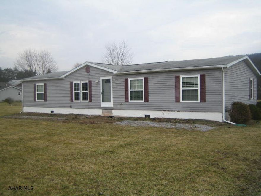 East Freedom double-wide property on half acre lot. Large living room, dining room, eat-in kitchen, 4 bedrooms, and 2 baths featuring large master suite. Vaulted ceilings and central air. Needs some work and being sold AS-IS.