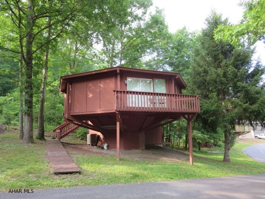 Contemporary octagon shaped home with lots of windows to bring the outside in. Nestled in the woods just across the street from the renowned Omni Bedford Springs and Golf Course. Open floor plan with 2 bedrooms and 2 full baths on the main level. Spiral staircase leads to the lower level family room. Great vacation home or full time residence. *MOTIVATED SELLER*