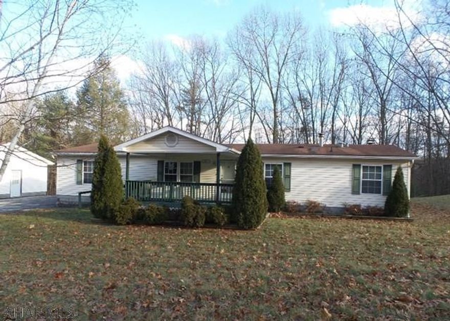 Wooded location with large 2+ car garage.  Double wide mobile home in disrepair.  3 bedrooms with 2 baths, living room, family room with fireplace, large covered deck.  Cash buyers only.