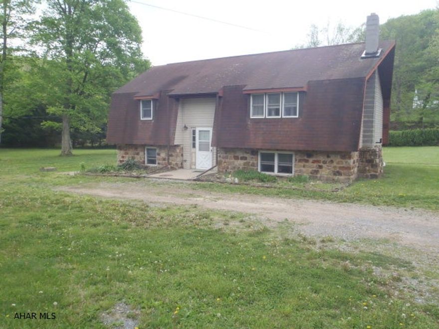 Plenty of outdoor space on this 4+- acre lot with brook, bridge, and firepit.  House needs some finishing, but features a large kitchen with moveable island, first floor laundry, jetted tub and shower stall, family room with stone walls and fireplace with woodburner insert, 2nd kitchen on the lower level.  Seller will leave cherry flooring if Buyer wants to use it.  Homeowners on the land maintain the lane. Seller had paid approx. $300 for flood insurance.