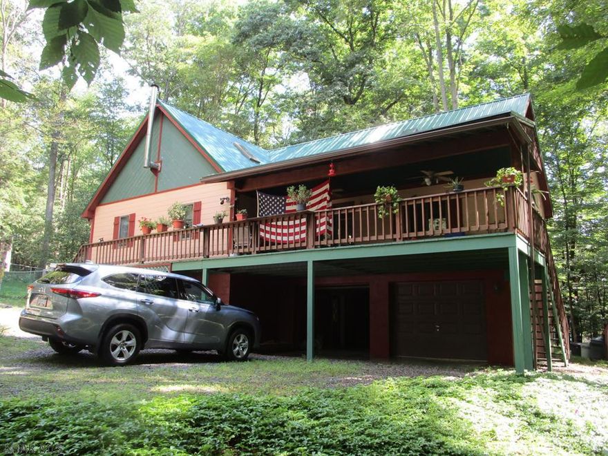 Private wooded lots surround this special place you will want to call home.  From the great room where you can snuggle in front of the fireplace in winter; to the extra large family room with windows on three sides that could easily become your master bedroom if you are looking for complete one floor living; to the wrap around porch / deck that allows you to enjoy nature and the wildlife just outside your door, this is country living.  For the practical issues you have a 2 car garage, 200A. service, a generator (just in case), a full bath on each living floor, two driveways for plenty of parking, new metal roof in 2018.  Glendale Yearound offers amenities such as a swimming pool, club house, dog park, etc. that complement those at the adjacent Glendale Lake/Prince Gallitzin State Park.