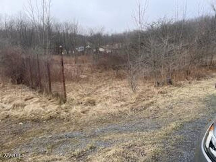 For sale sign at corner of Coupon Rd and Maple st.