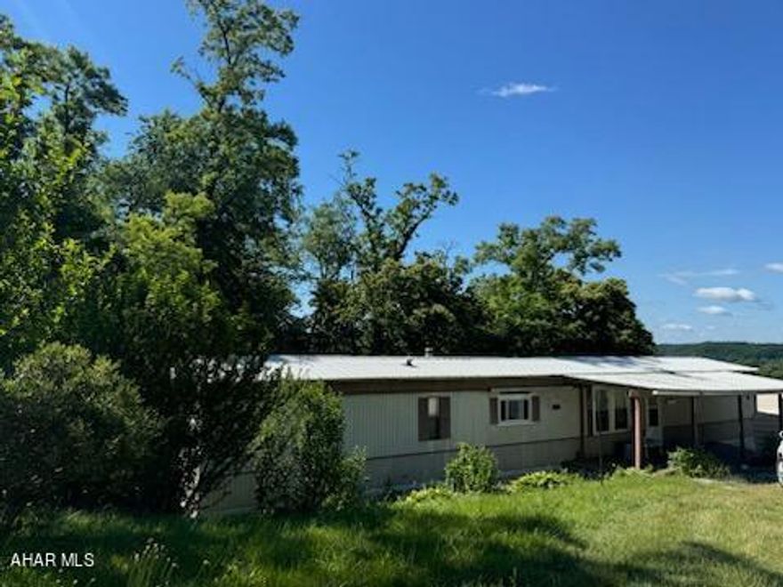 This mobile home is move in ready and just waiting for its new owner to make it their own.  When you enter the front door, enjoy the open floor plan with a large living room, a built in divider to the dining room, and the spacious kitchen with plenty of counter space. To your right is two bedrooms. One with a three bay window that allows lots of natural light.  A small bathroom divides the two. Turn to the left and past the kitchen you will find The master bedroom and master bathroom.  The bathroom has both a walk in shower and a tub, as well as a double bowl sink.  A carport and 2 large storage sheds come with the home as well. This home won't disappoint.  Call today to schedule a showing!