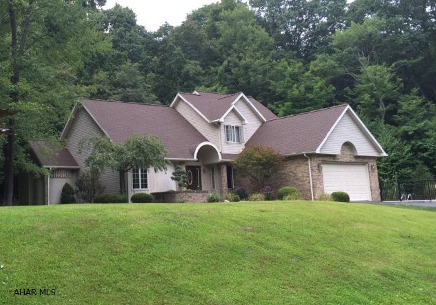 Bill Waltman constructed 3 bedroom 3 bathroom home in a private setting on 1 acre located less than  mile from Omni Bedford Springs.  Vaulted ceilings and rounded walls are just a few elements that make this home so unique. The master bedroom suite with vaulted ceilings has a private walk out to yard and pool. Dining room has tray ceilings. Floor to ceiling fireplace in family room opens onto the kitchen and walkout. Main floor laundry room. Second floor bedrooms share a private loft and Jack & Jill bathroom. Gorgeous in ground pool curved pool.