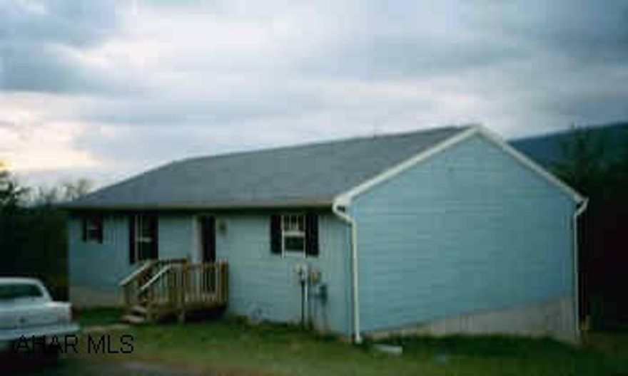 1 story blue house with walkout basement on over 2 acres. Needs repairs.  Raystown Lake area, home is located in private development on over 2 acres of private ground.