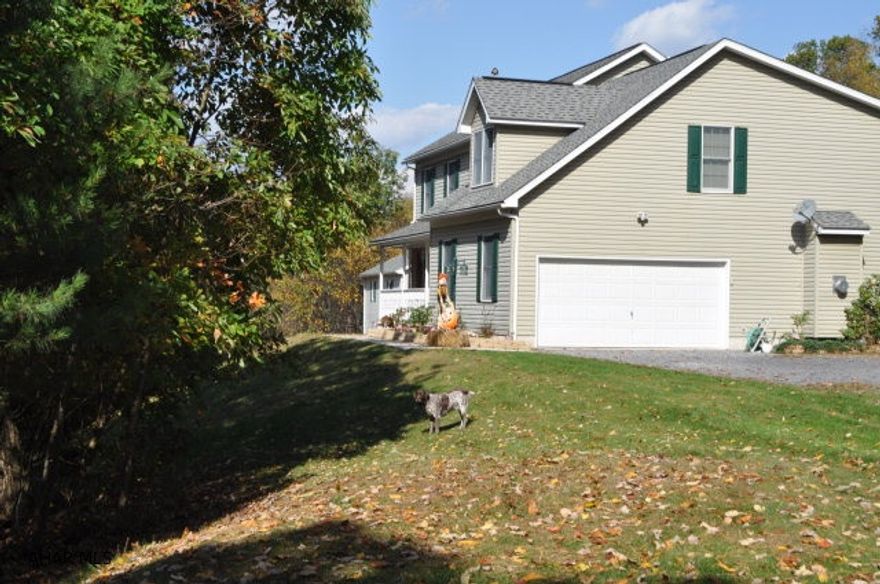 If you love the outdoors and have toys to store, you will love this property.  Spacious 4 Bedroom home with 3 bathrooms, 2 full kitchens and 3 heat sources.  The master suite has 2 walk in closets, a master bath with garden tub and space galore.  There is a separate 2 story garage 30x36 and a new metal pole building which is 24x40.  It has a heat pump with central air and a tankless water heater.