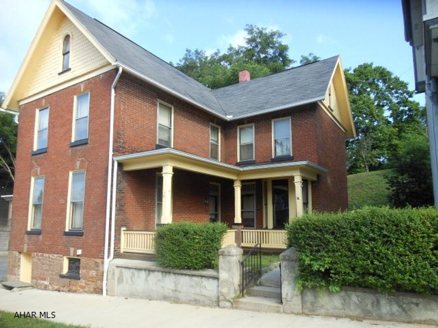 Solid brick home with large bedrooms, hardwood floors, large eat in kitchen and relaxing front porch. Room for garage in back. Needs TLC