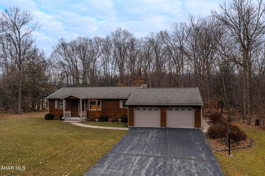 Welcome to the most serene ranch home on the corner of Christy Lane in Tyrone. This must see property has only had one owner and has been kept extremely well. The rain gutters have professionally installed leaf guards. There is a 2 car attached garage with large attic pulldown storage. A 1 car detached garage with electric and plenty more storage. The driveway has a great amount of parking to include seperate space for an RV. Out back is a huge covered deck, patio and firepit where you can enjoy the views of the forest and sounds of the nearby stream. It is truly beautiful! Inside you will find a first floor laundry room with sink, a wide open floor plan to incude the kitchen, dining, living room with central vac. 2 bedrooms with great closets and 1 full bath. Cozy up to the stone fireplace or open the french doors to let in warm breezes. The basement is currently a blank canvas ready for your imagination. All located minutes from local schools, shops, restaurants and I-99. Matterport virtual walkthrough avaliable. Schedule your showing today!