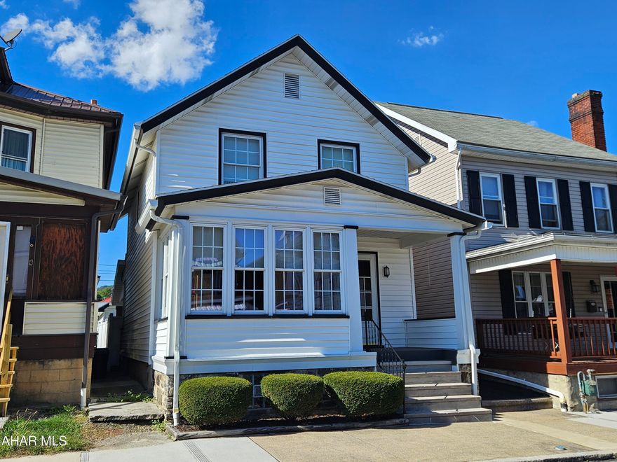 This impeccably maintained home has seamlessly integrated through the eras.  Built in 1916, this property has been updated tastefully while maintaining its charm and unmatched craftsmanship.  Beautiful original woodwork through out the home including pocket doors and tall baseboard with solid doors.  Beautiful hardwood floors that have been preserved under plush carpets.  A delightful sunroom fronts the home allowing for an abundance of natural light.  Enjoy the breakfast nook just off the kitchen or just a few steps and your outside on a wonderful 14x10 covered concrete patio walled with brick that overlooks the yard.  The master bedroom features a ceiling fan and 2 closets while the other 2 bedrooms each have closets and ceiling fans also.    The mechanics have all been updated; newer roof, newer windows, new hot water tank.  As you head into the basement, don't miss the charming original built-in cabinets from 1916 that add historic character.  The basement is pristine with an abundance of storage space and a ''3/4'' bath.  There is also a cedar lined closet, a 10x6 storage room and a 7x6 canning storage room with shelves.  The original owner of the home built a workbench that will remain with the house - any handyperson will appreciate the quality and nostalgia of the old vice!  The garage is spacious enough for 2 cars plus storage.  This is not a home that you can pass up!