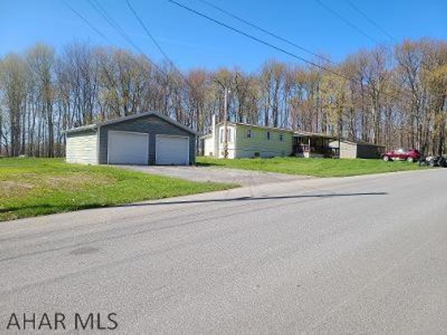 Single-wide mobile home on a full foundation.  The basement has high ceilings and a walk out.  There is a large family room addition on the back of the home.  The 1.3 acre lot gives you plenty of room to call your own.  There is a huge workshop to the right of the trailer that is well insulated, and has electric.  All this plus a "man-cave" shed & a 2-car garage!  Nice, quiet location!