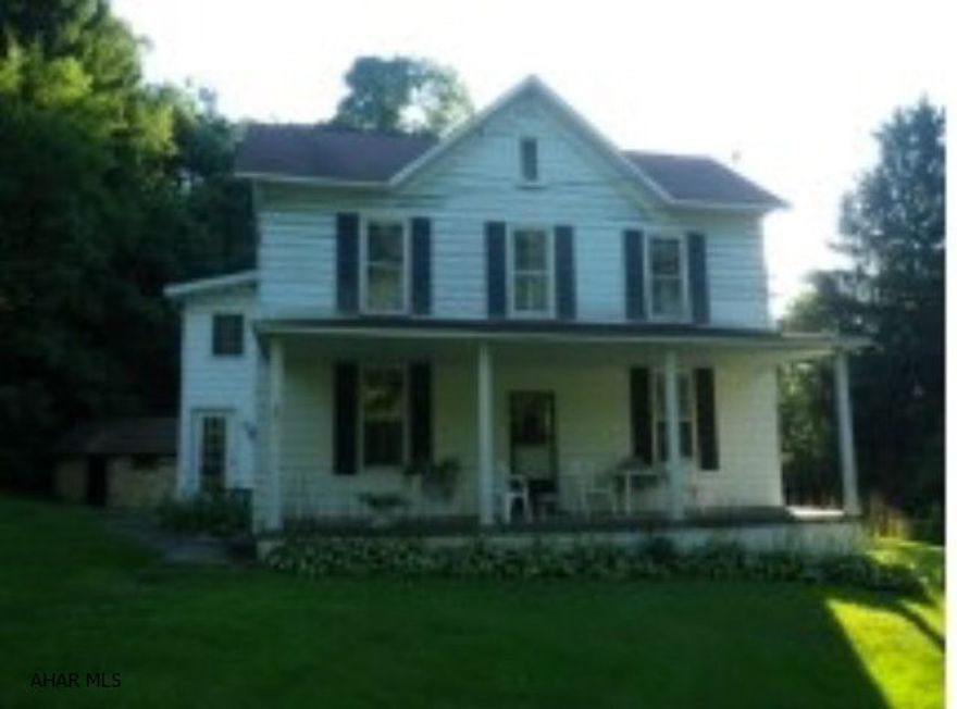 16 acres secluded in the country. Huge updated farmhouse, built in the 1800's. 4 BRs, 2 baths, large rooms. Oil & coal HW heat.   workshop. Spring & public water. Spring fed pond. Fruit trees, grape arbor. Country living at its finest.