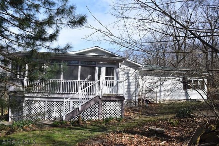 Beautiful wooded lot (almost an acre) and a screened wrap-a-round porch you will never want to leave.  Nicely remodeled interior with a huge master suite with sitting area and  lots of natural light.  You will love the stained glass accents and windows throughout this home.  Hardwood and ceramic tile flooring.  Very nice finished room in basement and the possibility to finish more space on that level.