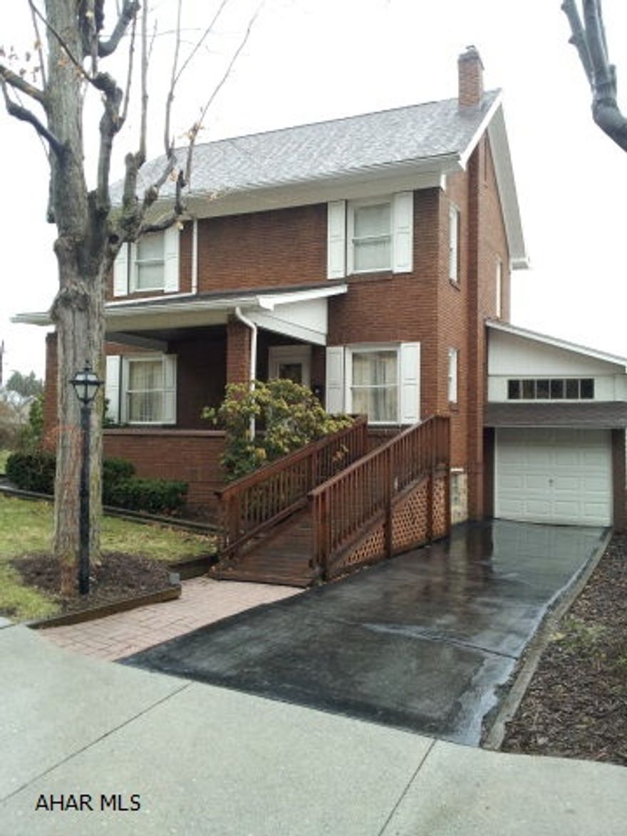 Nice 2 1/2 story Brick home with central air, new roof, 2 car garage in back of  house, 1 car garage connected to house. Hardwood floors in bedrooms, and under carpet in living room. Powder room off kitchen. Well maintained.