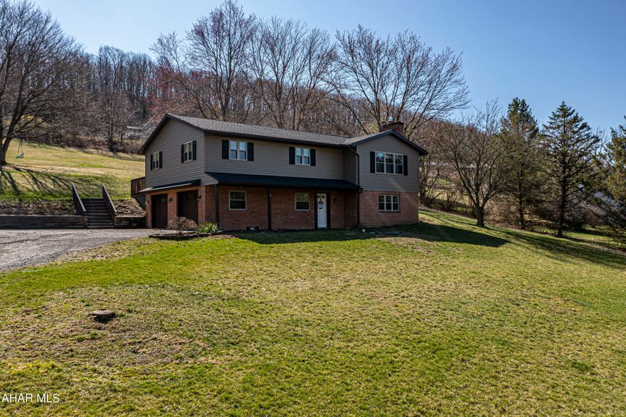 BEAUTIFUL move-in ready modern bilevel home on almost 2 acres in a quiet desirable neighborhood in Scotch Valley - Hollidaysburg Area School District. There are so many desirable features to this home and property. 1st floor features: a huge finished basement family room with bathroom and handmade bar, perfect for entertaining guests. 2nd floor features: open concept eat-in kitchen with a HUGE island facing the living room with a large window boasting views of the valley and mountainside. 3 bedrooms with a guest bathroom and en suite bathroom in the primary bedroom. This home sits on almost 2 rolling acres with an open field, stunning views of the valley, shed, large deck off of the kitchen, invisible fence for your pets, and fire pit - perfect outdoor space for relaxation and privacy. This home is perfect for any family and their pets to move right into!! Schedule your showing today!!