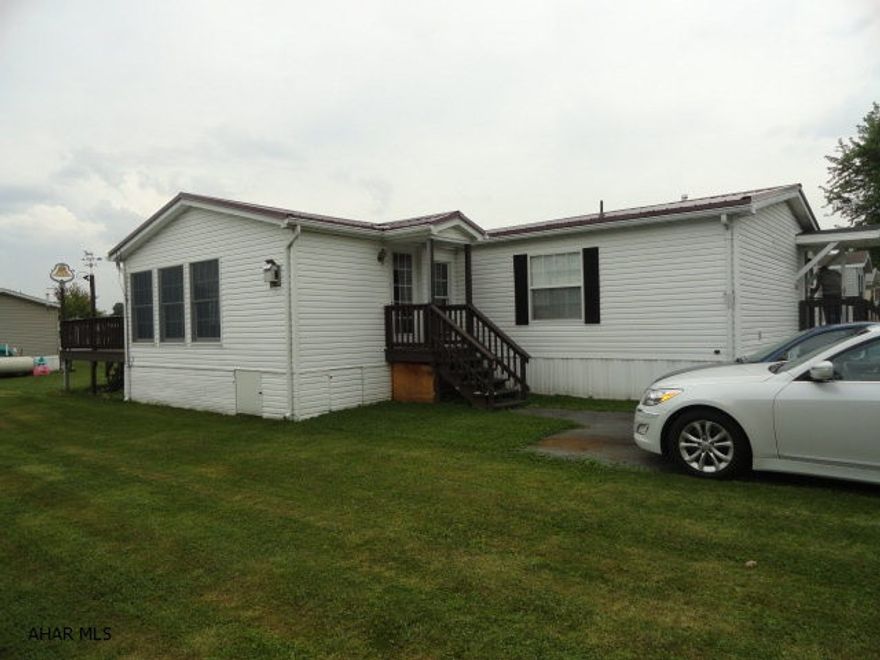 Nice double wide on rented lot in quiet Spring Drive Mobile Home Park next to Homewood Retirement Home in Martinsburg. Measured livable space of double wide is 52 x 26'. Large 20 x 14' Sunroom addition with knotty pine walls and cathedral ceiling with gas corner fireplace. Newer metal roof. Total square footage includes sunroom. Rear deck and shed. Lot rent only $180 includes garbage.