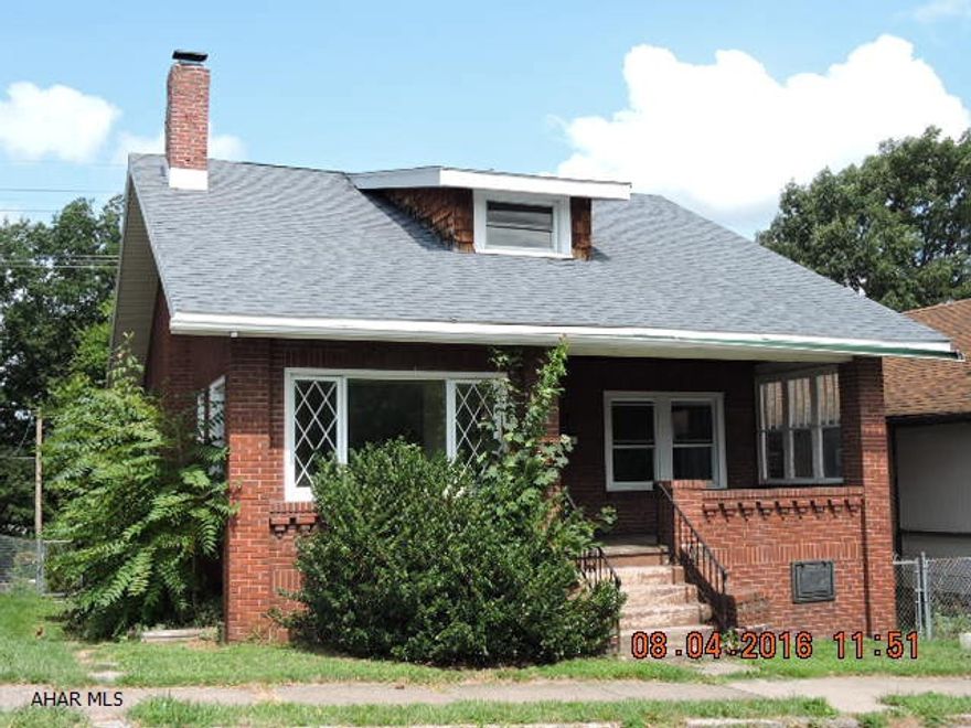 tons of potential with this 1.5 story brick home. hardwood floors and fireplace in living room. Large finished 2nd floor could be 3rd bedroom has no heat. Needs tlc.  Evidence of freeze damage.  As is sale.