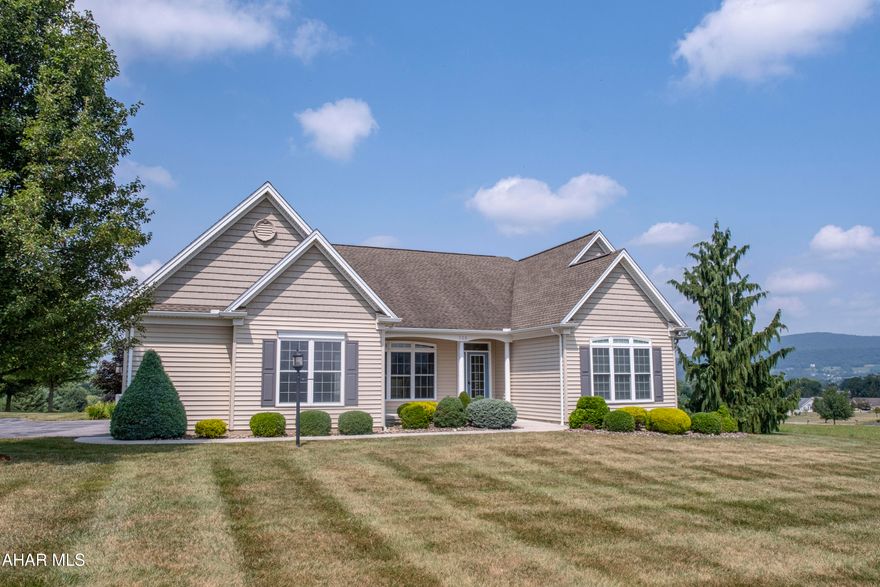 OPEN HOUSE SATURDAY OCTOBER 11TH FROM 2:00-3:30!
Welcome to a home designed with comfort, practicality, and relaxed living in mind. This beautifully maintained 3-bedroom, 2.5 bath ranch offers an open, airy layout ideal for a low-maintenance lifestyle. The main living area feels bright and inviting with its open-concept design, skylights, dimmable LED lighting, and a cozy gas fireplace flanked by built-in shelving. Whether you're enjoying a quiet morning or unwinding in the evening, this space feels both warm and functional. In the kitchen, you'll find custom white oak cabinetry, granite countertops, and a generous pantry. There's plenty of room for everything you need, with thoughtful finishes that blend style and convenience. The primary suite is a true retreat, with large windows that bring in natural light, a spacious walk-in closet, and a well-appointed bath featuring double sinks and a walk-in tile shower. Two additional bedrooms provide space for guests, hobbies, or a home office. A large first-floor laundry room with shelving keeps everything easily accessible, and a 3-season sunroom lined with windows offers a peaceful spot to read, relax, or enjoy the outdoors—without leaving the comfort of home. Radiant heat keeps the home evenly warm through the seasons. Step outside to enjoy the beautifully landscaped yard from your wraparound covered porch. A gas line is ready for your grill, and the attached 2-car garage adds even more convenience. This home was built for easy, comfortable living in the welcoming Mountainview Estates' prestigious 55+ community at The Village at Morrisons Cove —come see what makes it so special.