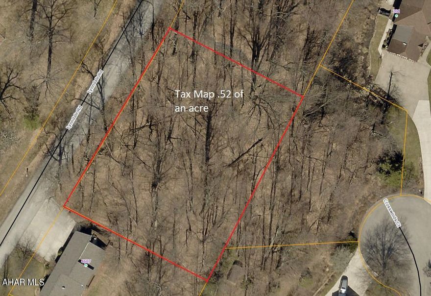 Wooded building lot with public water and sewer available. Property located across from Highland Park.