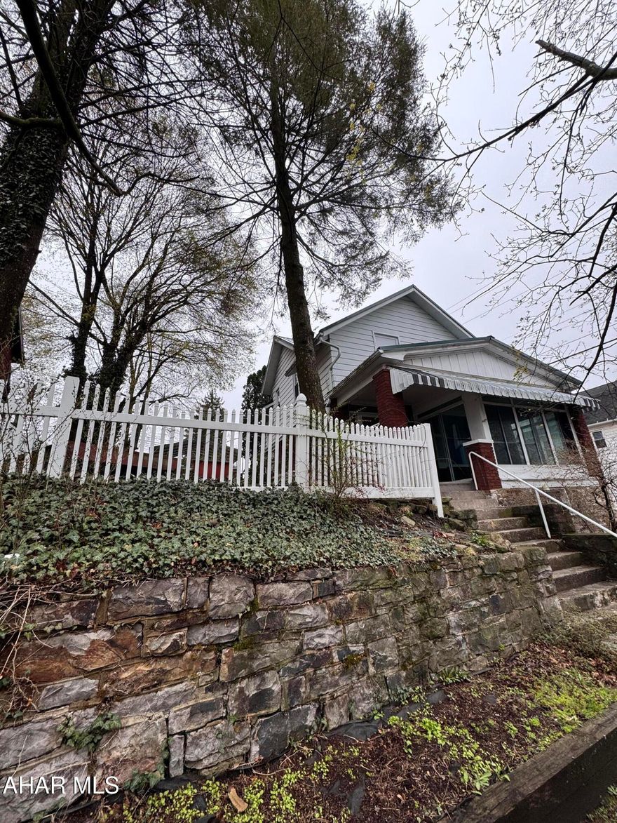 This is a completely updated home on a corner lot, ready for a new owner! The entire inside has been tastefully updated with new flooring, paint, and ceiling fan. The living room and dining area are spacious, and there is a nice size bonus room on the first floor that can potentially be used for a fourth bedroom. The stairway has attractive shiplap, creating a nice flow to the second floor. On the second floor, you'll find a private bedroom tucked in the corner of the home, along with a second and third bedroom that share a walk-in closet. The bathroom has been fully updated, top to bottom! Outside, you'll find a nice area for entertaining in the partially fenced yard. There is a one car-garage, next to a brand new retaining wall. For additional parking, this property offers a two-car carport just above the property. To the right of the front door offers an enclosed front porch. This property has a new metal roof as well! This is a gem in the city of Altoona!