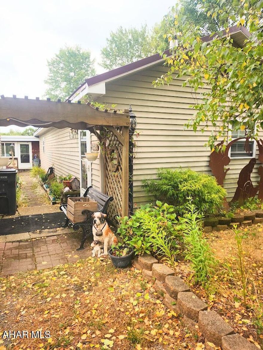 Charming 1-story frame house located just 5.2 miles from historic Schellsburg, PA. This home features 2 bedrooms, 1 bathroom, a kitchen, living room, dining room, and sunroom. Situated on a beautiful 1-acre lot, it offers stunning countryside views and ample space for gardening and outdoor activities. The property includes a 2-car garage and additional outbuildings. Nearby attractions include Shawnee State Park, which offers hiking, fishing, swimming, and boating on Shawnee Lake, and historic Schellsburg, where you can explore 19th-century architecture and charming local shops. Visit the Old Log Church, built in 1806, or experience the unique optical illusion of Gravity Hill. This lovely home combines rural charm with easy access to Schellsburg's attractions and amenities, making it perfect for those seeking tranquility and outdoor adventure.